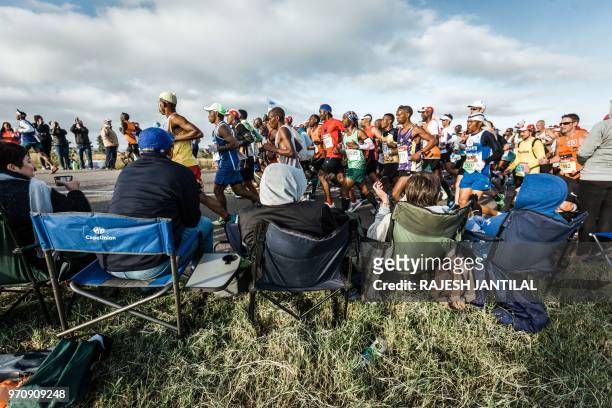 People cheer runners along during the 89km Comrades Marathon between Pietermaritzburg and Durban on June 10, 2018.The annual ultra marathon this year...