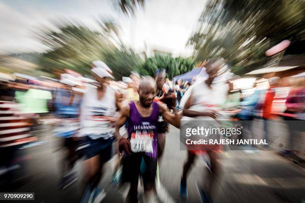 People cheer runners along during the 89km Comrades Marathon between Pietermaritzburg and Durban on June 10, 2018.The annual ultra marathon this year...