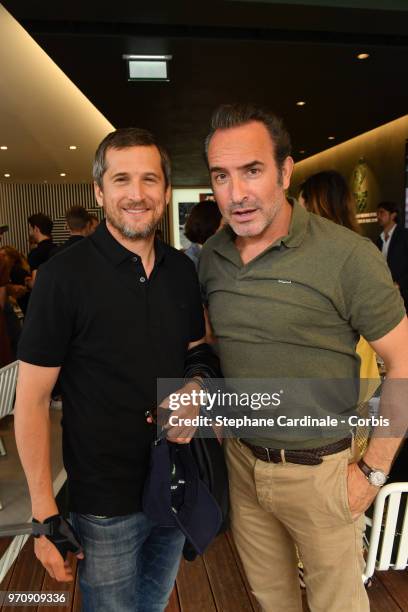 Guillaume Canet and Jean Dujardin attend the Men Final of the 2018 French Open - Day Fifteen at Roland Garros on June 10, 2018 in Paris, France.