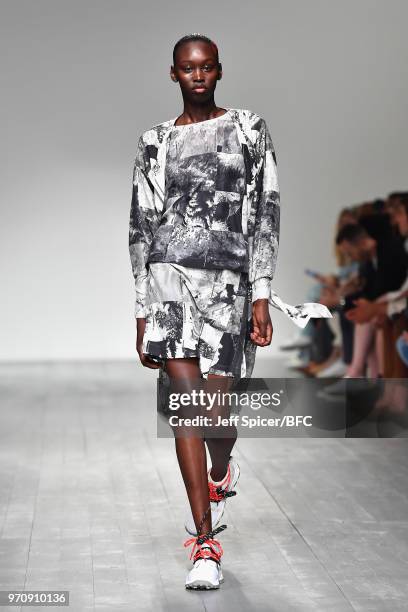 Model walks the runway at the Christopher Raeburn show during London Fashion Week Men's June 2018 BFC Show Space on June 10, 2018 in London, England.