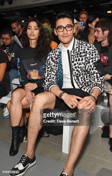 Adrianne Ho and Hu Bing attend the Christopher Raeburn show during London Fashion Week Men's June 2018 at the BFC Show Space on June 10, 2018 in...
