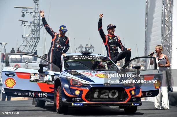 Belgium's driver Thierry Neuville and compatriot co-driver Nicolas Gilsoul of Hyundai i20 Coupe WRC, celebrate as they won the 2018 FIA World Rally...