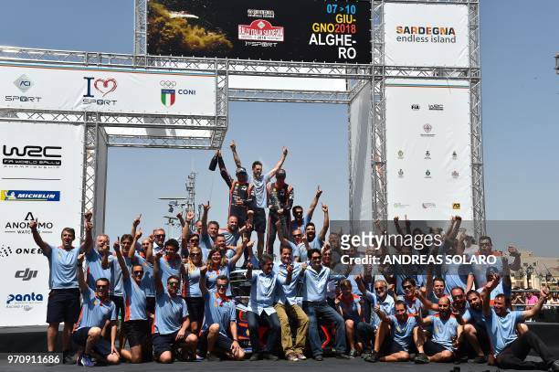 Belgium's driver Thierry Neuville and compatriot co-driver Nicolas Gilsoul of Hyundai i20 Coupe WRC, celebrate thier victoty on the podium during the...