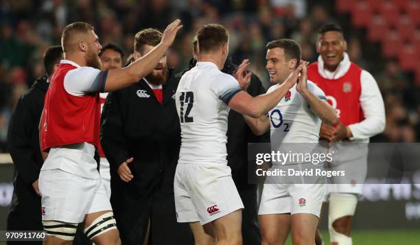 Owen Farrell of England is congratulated by team mate George Ford after scoring a try during the first test match between South Africa and England at...