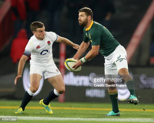Willie le Roux of South Africa off loads the ball watched by George Ford during the first test match between South Africa and England at Elllis Park...