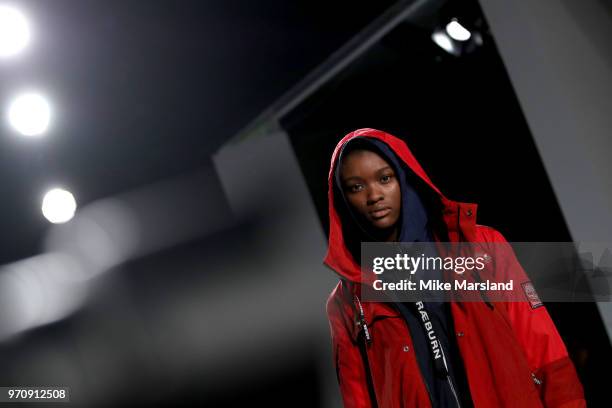 Model walks the runway at the Christopher Raeburn show during London Fashion Week Men's June 2018 at the BFC Show Space on June 10, 2018 in London,...