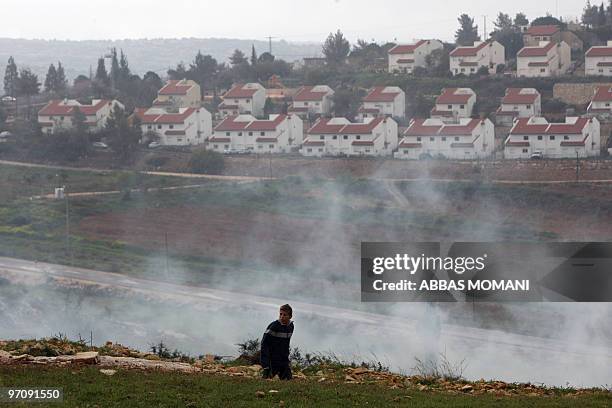 Palestinian boy collects stones to throw at Israeli soldiers firing tear gas during clashes in the village of Nabi Saleh, near Ramallah, following a...