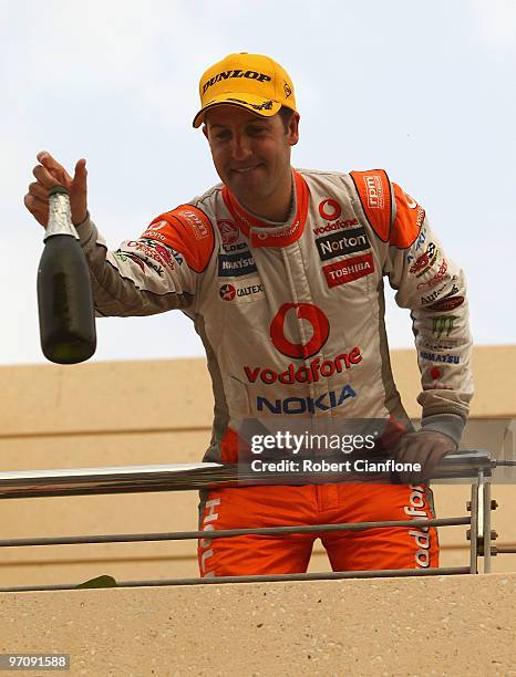 Jamie Whincup driver of the Team Vodafone Holden celebrates after winning race one for round two of the V8 Supercar Championship Series at Bahrain...