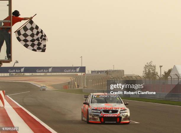 Jamie Whincup driving the Team Vodafone Holden crosses the line to win race one for round two of the V8 Supercar Championship Series at Bahrain...