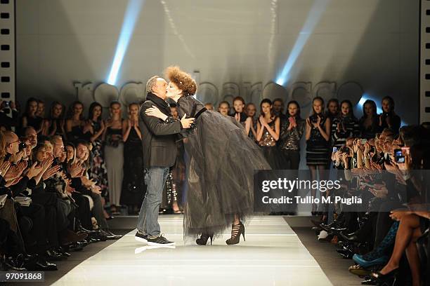 Italian designer Rocco Barocco acknowledges the applause of the public after the RoccoBarocco Milan Fashion Week Autumn/Winter 2010 show on February...