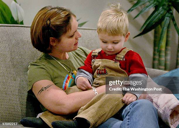 Waltreed Photos by Michael Williamson NEG#163143 12/21/04- Belinda Beatty, wife of injured Iraq war vet Dale Beatty talks her son Dustin at the...