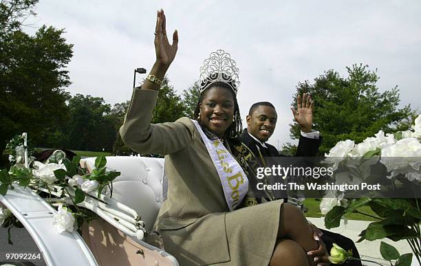 Pg-home14 10-09-04 Bowie, Md. Mark Gail_TWP Ms.Bowie State University Tameka Wilson and Mr. Bowie State University Asante Mc Gee wave to the crowd...