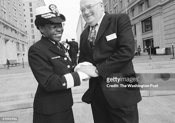 Rear Admiral Lillian E. Fishburne, left and Rear Admiral Henry McKinney shake hands following a wreath-laying ceremony at the Navy Memorial in...