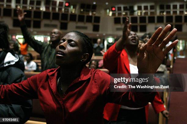 Jahi chikwendiu Melanie B. Kelly prays during Wednesday night service at the Reid Temple African Methodist Espiscopal Church in Glenn Dale, MD. In...