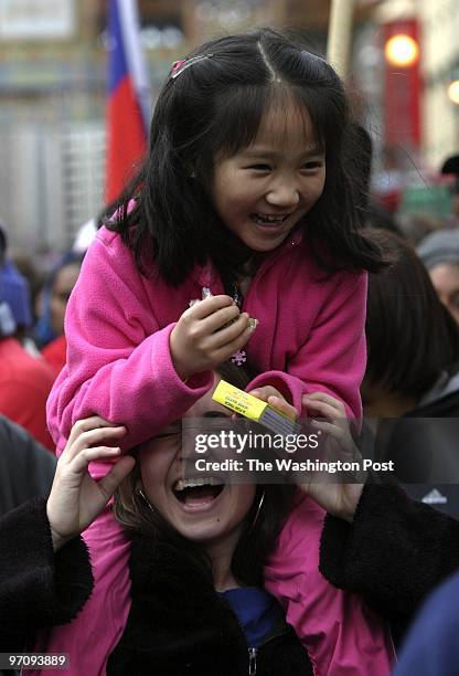 Ada Zuo and Noelle Knight enjoy themselves as participants in the 2005 Chinese New Year celebration parades dow H St. NW to celebrate the year of the...