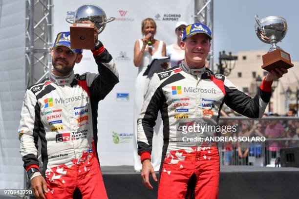 Finnish driver Esapekka Lappi and co-driver Janne Ferm, steer their Toyota Yaris WRC, hold their trophies as they celebrate on the podium the third...