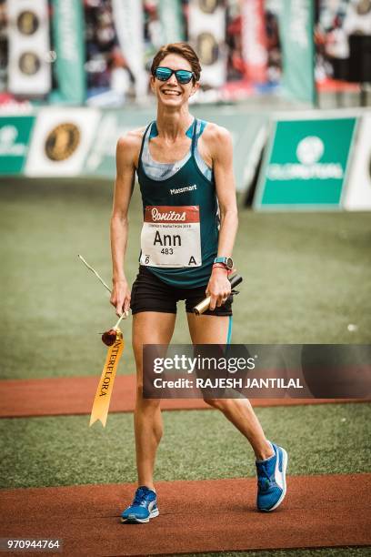 South African long-distance runner Ann Ashworth reacts after passing the finish line and winning the 89km Women's Comrades Marathon between...