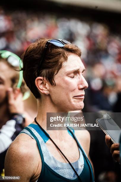 South African long-distance runner Ann Ashworth reacts after passing the finish line and winning the 89km Women's Comrades Marathon between...