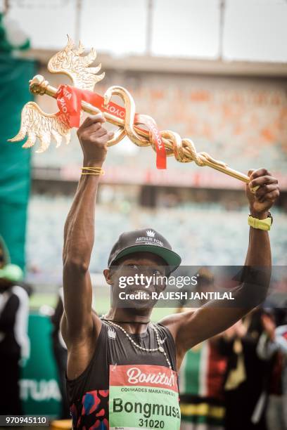 South African long-distance runner Bongmusa Mthembu reacts after passing the finish line and winning the Mens 89km Comrades Marathon between...