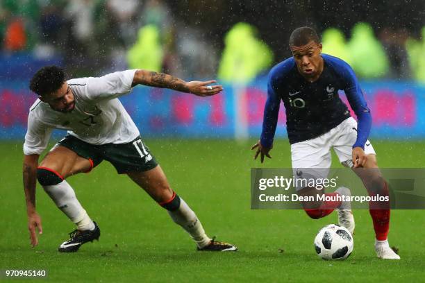 Kylian Mbappe of France gets past Derrick Williams of Ireland during the International Friendly match between France and Ireland at Stade de France...
