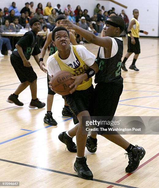 Thanks, vbh *** pg-cover24 03-19-05 Mark Gail_TWP South Bowie Community Center's Timothy Fitzgerald looks to shoot over Peppermill Community Center's...