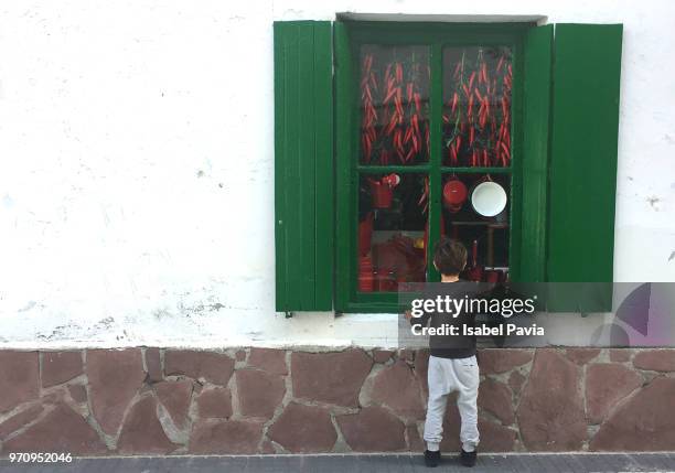 boy in front of rural shop - isabel pavia stock-fotos und bilder