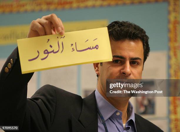 Gaithersburg High School, MD Nazeh Natur goes through a list of words in Arabic, translated "Good Evening," during a class at Gaithersburg High...