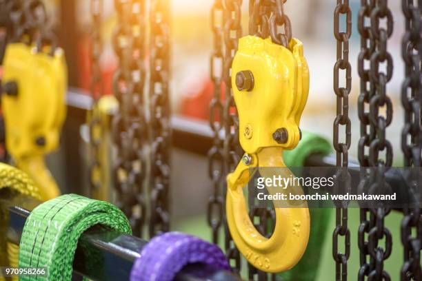 chain and yellow hoist on background - issare foto e immagini stock