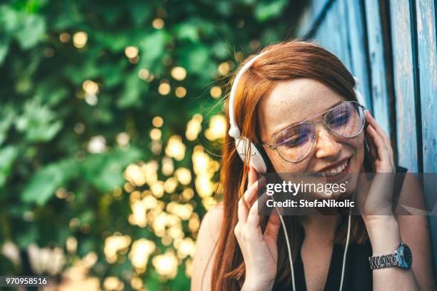cheerful freckled girl - personal stereo stock pictures, royalty-free photos & images