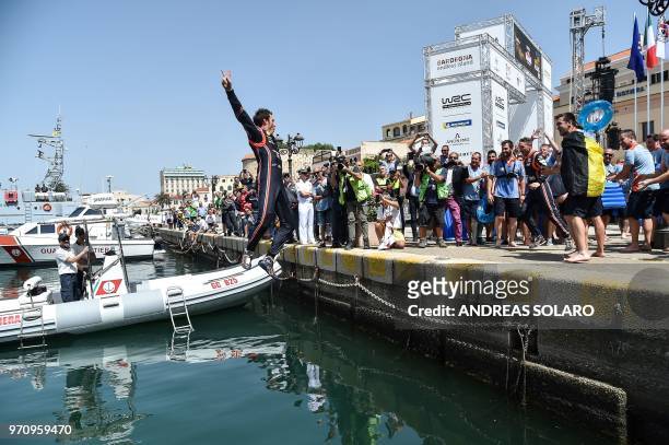 French driver Sebastien Ogier and co-driver Julien Ingrassia of Ford Fiesta WRC, jump in the water as they celebrate by swimming after winning the...