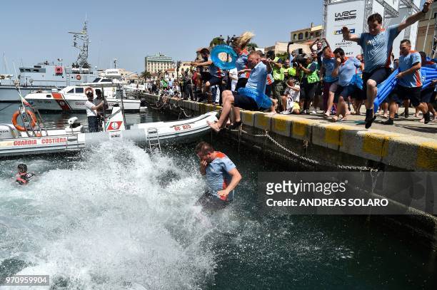 French driver Sebastien Ogier and co-driver Julien Ingrassia of Ford Fiesta WRC with their team staff, jump in the water as they celebrate after...