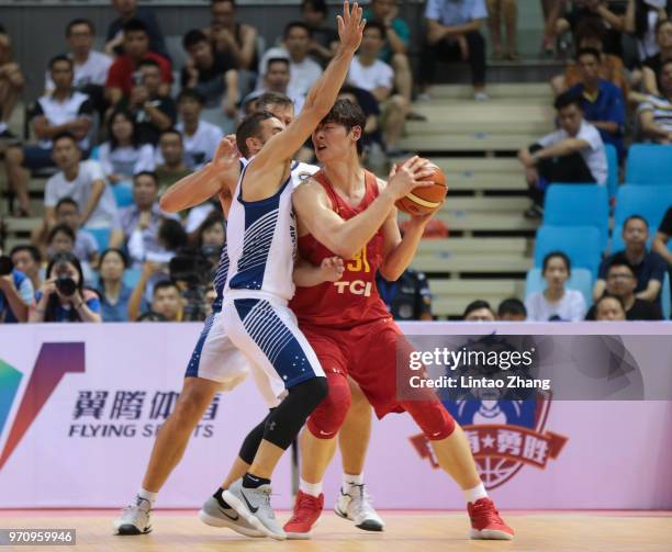 Wang Zhelin of China drives to the basket against Adam Gibson of Australian during the 2018 Sino-Australian Men's Internationl Basketball Challenge...