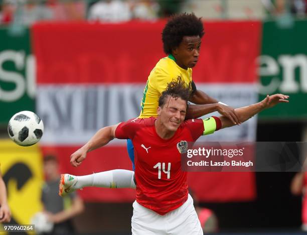 Willian of Brazil fights for a ball with Julian Baumgartlinger of Austria during an International Friendly match at Ernst Happel Stadium on June 10,...