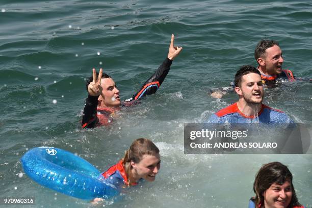 French driver Sebastien Ogier and co-driver Julien Ingrassia of Ford Fiesta WRC with their team staff celebrate by swimming after winning the 2018...