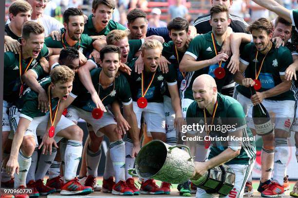 Thilo Stralkowski of HTC Uhlenhorst Muelheim lifts the trophy on the podium after winning 3-2 the mens final match between Rot-Weiss Koeln and HTC...