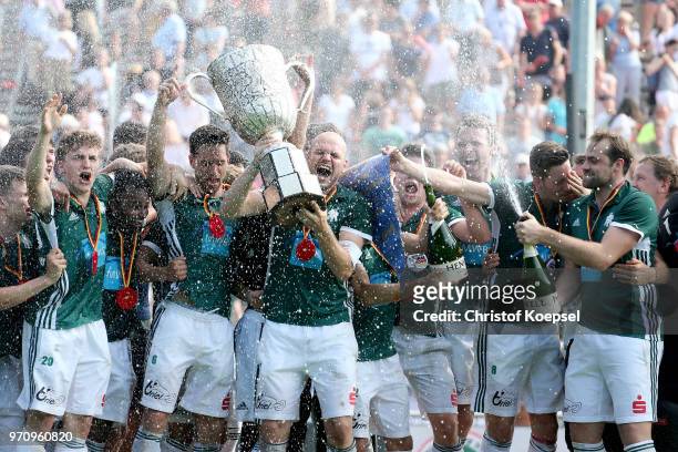 Thilo Stralkowski of HTC Uhlenhorst Muelheim lifts the trophy on the podium after winning 3-2 the mens final match between Rot-Weiss Koeln and HTC...