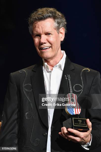 Randy Travis receives an award during the 2018 CMA Music festival on June 9, 2018 in