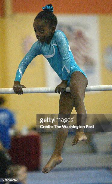 Pg-gymnast10 03-05-05 Mark Gail_TWP Kennedy Jones with the Prince George's County's Sportplex Gymnastics team on the uneven bars at the 28th annual...