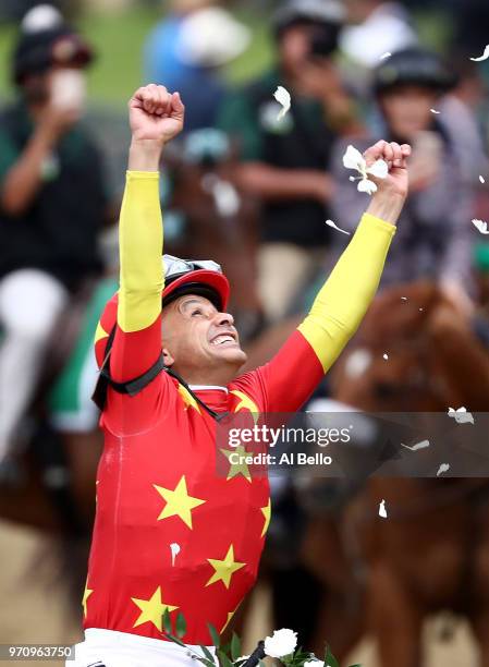 Jockey Mike Smith celebrates atop of Justify during the 150th running of the Belmont Stakes at Belmont Park on June 9, 2018 in Elmont, New York....