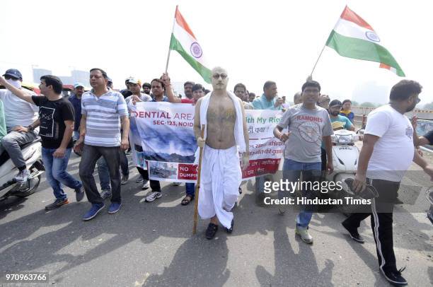 Residents from Noida Extension during a march against the dumping ground at Sector 123, on June 10, 2018 in Noida, India. The National Green Tribunal...
