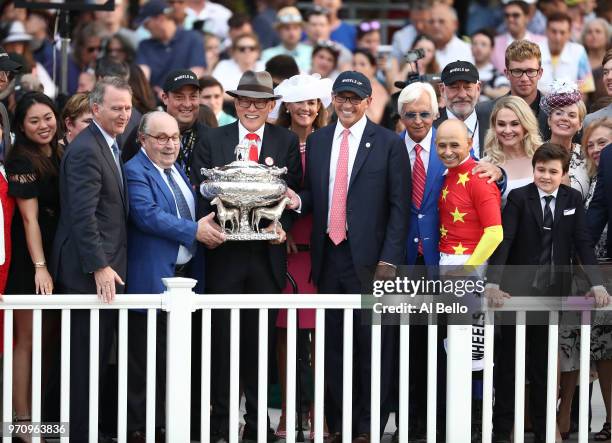 Teo Ah Khing poses with the Belmont Stakes Trophy during the post parade the 150th running of the Belmont Stakes at Belmont Park on June 9, 2018 in...