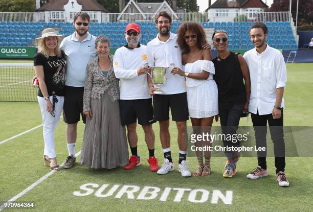 Jeremy Chardy of France celebrates with the Surbiton Trophy and his girlfriend and team after his victory over Alex De Minaur of Australia during...