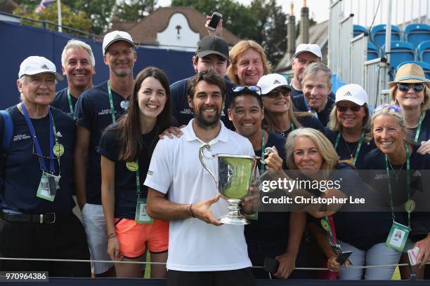 Jeremy Chardy of France celebrates with the Surbiton Trophy and with volunteers after his victory over Alex De Minaur of Australia during their Mens...