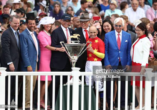 Owner Kenny Trout and Jockey Mike Smith pose with the Triple Crown Trophy after the 150th running of the Belmont Stakes at Belmont Park on June 9,...