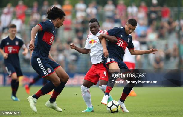 Oliver Batista Meier and Joshua Zirkzee of FC Bayern Muenchen U17 compete with Kossivi Amededjisso of RB Leipzig U17 compete during the B Juniors...