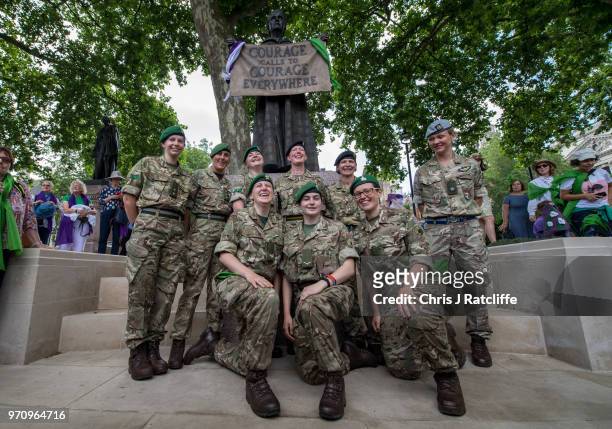 Group of female soldiers pose for a photograph next to a statue of Millicent Fawcett in Parliament Square after taking part in mass participation...
