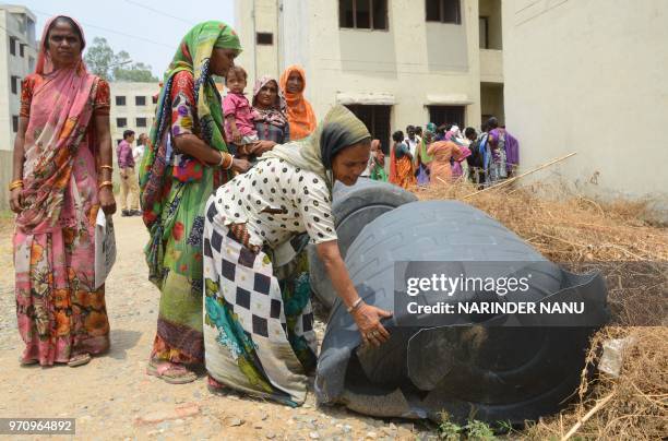 Indian Residents show damaged water tanks during a demonstration against poor workmanship by Amritsar Improvement Trust, at Basic Services for Urban...