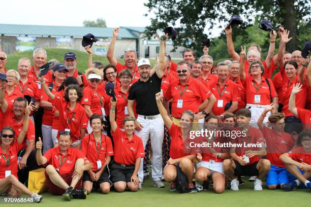 Mikko Korhonen of Finland pose for a photo with volunteers after he won The 2018 Shot Clock Masters during day four of The 2018 Shot Clock Masters at...