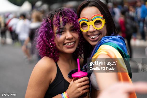 sisters celebrating carnival at street - teen lesbians stock pictures, royalty-free photos & images