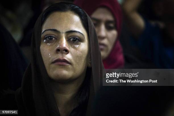 Woman cries while waiting to see her husband, an Iraqi detainee, during their visitation hour at Camp Bucca. Camp Bucca is a holding facility for...